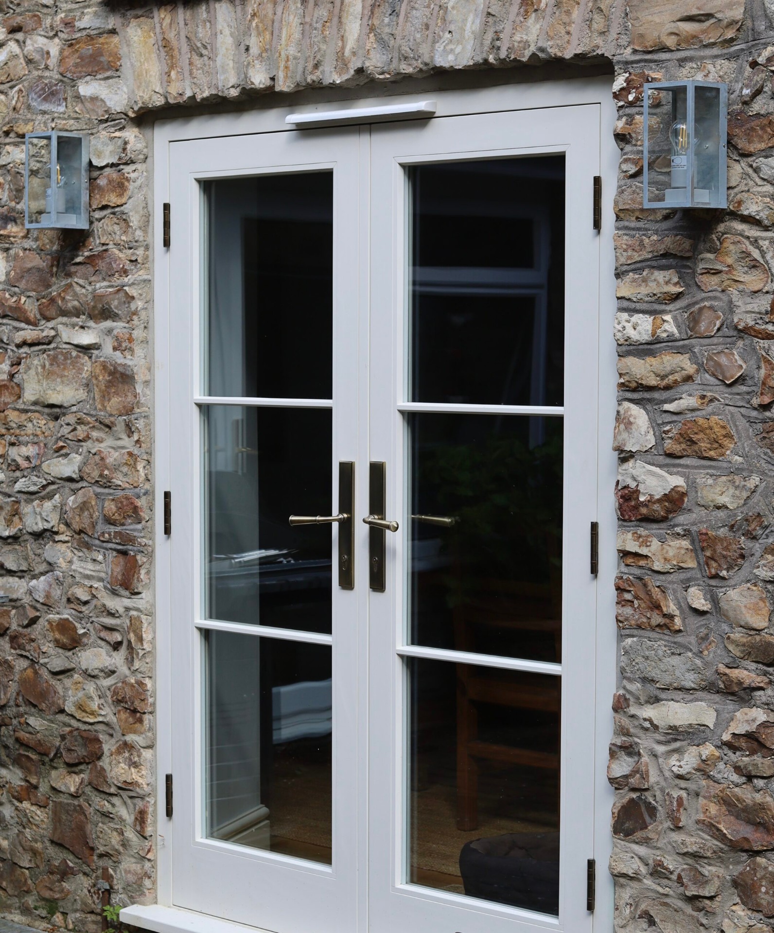 Handcrafted timber French doors set in stone